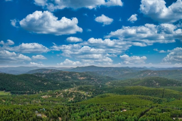 Aerial view of the surrounding Evergreen, Colorado pine forest and foothills